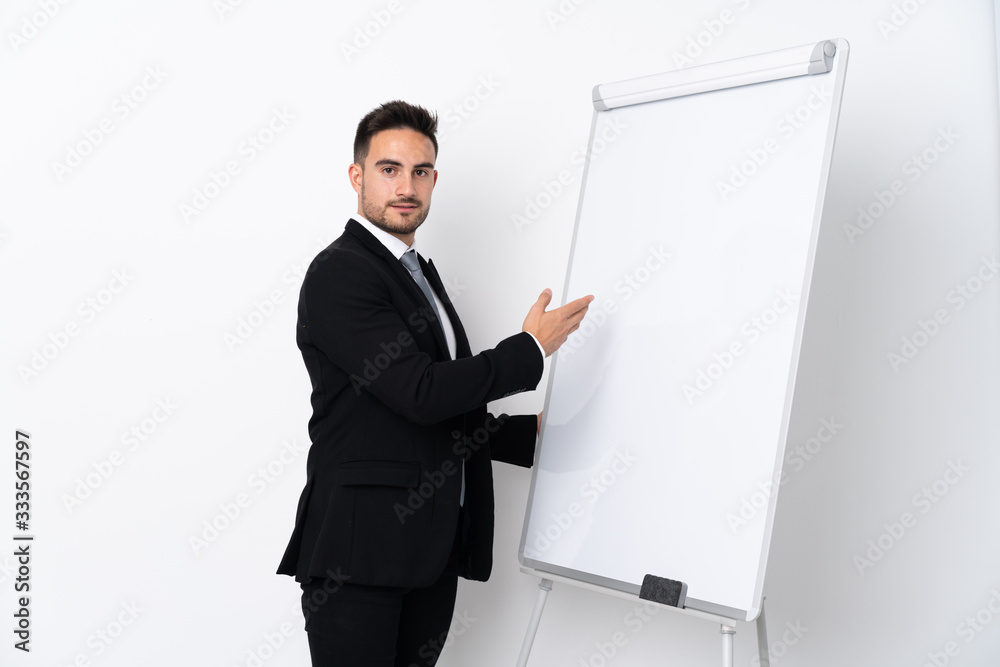 Young man giving a presentation on white board Young man giving a presentation on white board