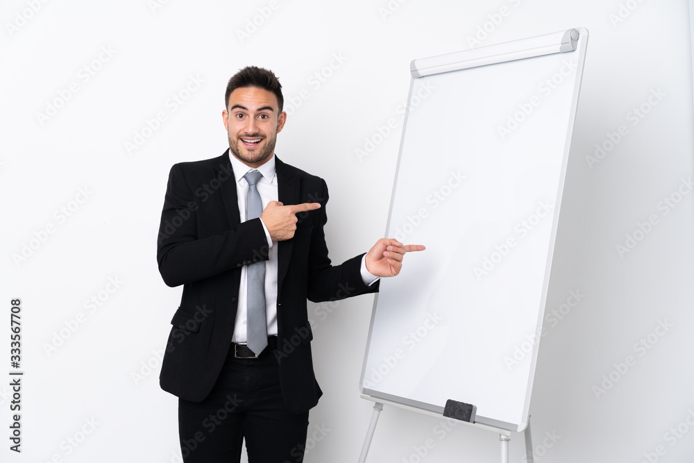 Young man giving a presentation on white board and surprised while pointing side Young man giving a presentation on white board and surprised while pointing side