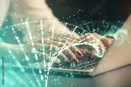 Double exposure of woman hands typing on computer and DNA hologram drawing. Medical education concept. © peshkova