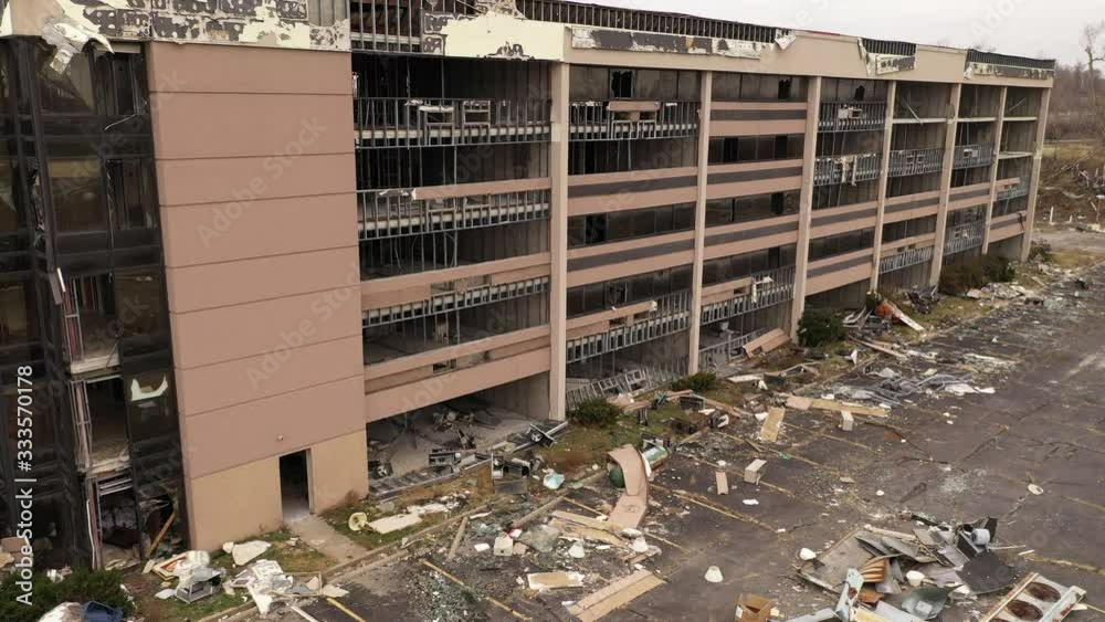 Establishing shot of demolished business building from tornado that came through city.
