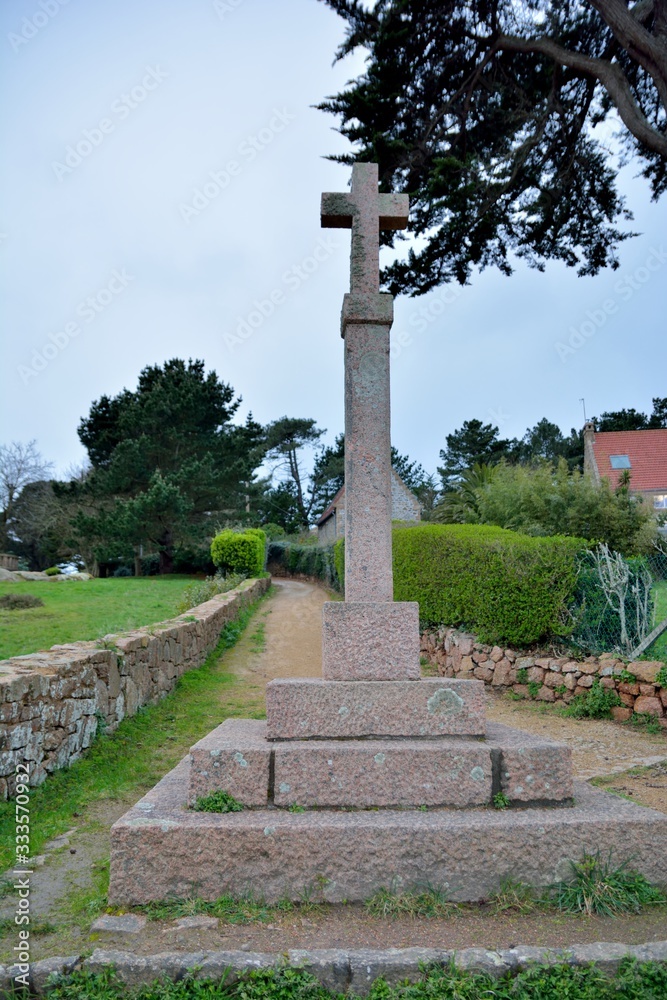 Religous cross in granite stones on the path at Ploumanach. Brittany, France