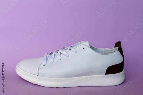 White sneakers on light pink background