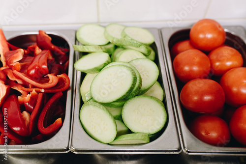 Wallpaper Mural Variety of sliced vegetables prepped for cooking in a professional kitchen, such as bell pepper, zucchini, tomatoes Torontodigital.ca