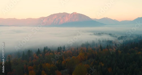 Snoqualmie Valley Washington USA Aerial Overhead View Flying Above Fall Colored Foogy Forest towards Mount Si at Sunset photo
