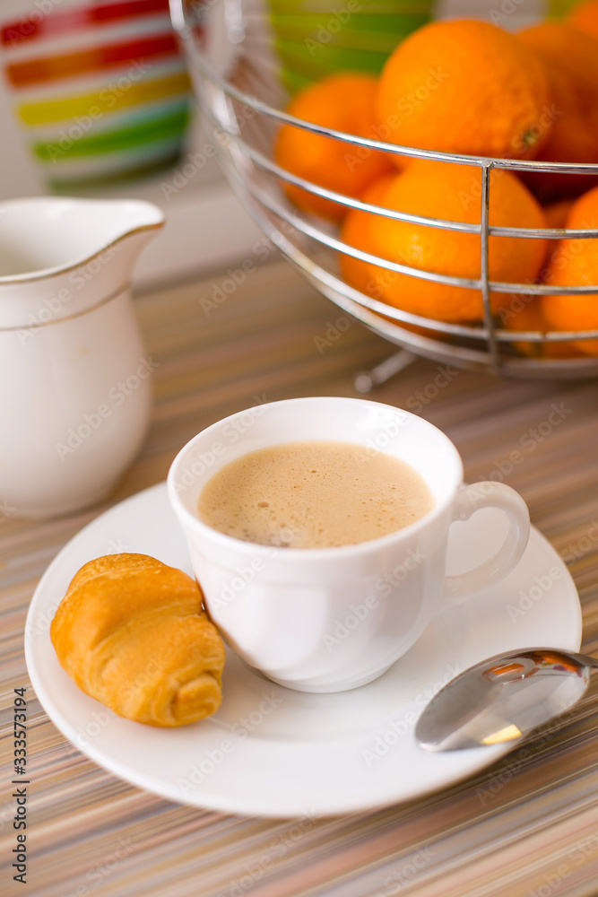 A mug of black coffee with fresh French croissant. Healthy breakfast. A mug of black coffee with fresh French croissant. Healthy breakfast.