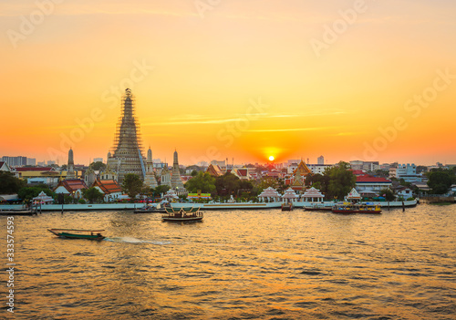 Temple of the dawn, Was Arun by riverside in Bangkok at sunset with golden sunlight © kityyaya