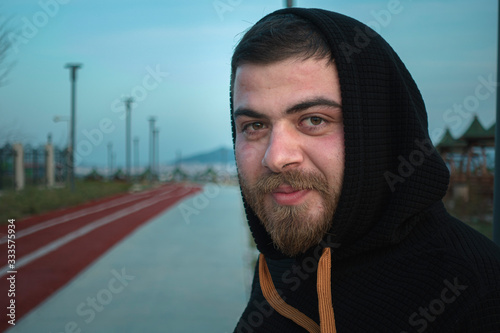Sportsman looking and smiling hopefully on running track