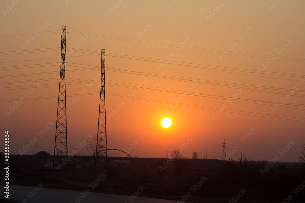 Sunset on the background of the road and antennas. Beautiful landscape. Background.