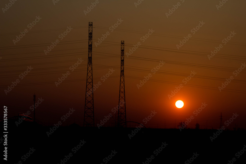 Fototapeta premium Sunset on the background of the road and antennas. Beautiful landscape. Background.