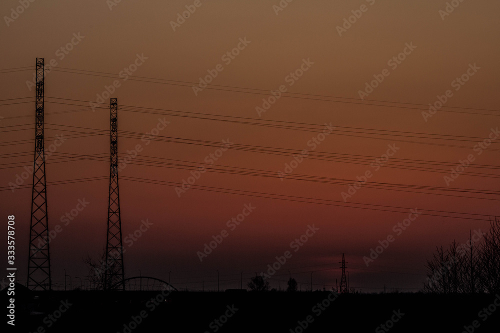 Fototapeta premium Sunset on the background of the road and antennas. Beautiful landscape. Background.