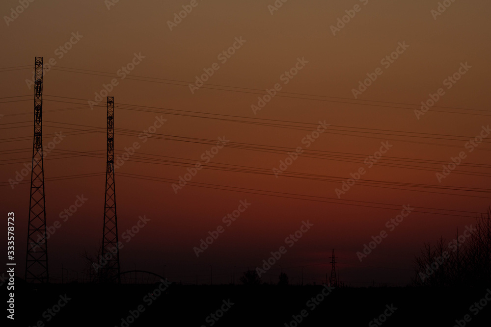 Fototapeta premium Sunset on the background of the road and antennas. Beautiful landscape. Background.