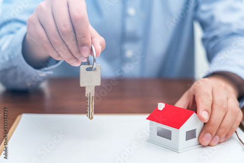 Real estate agent holding building key in hand