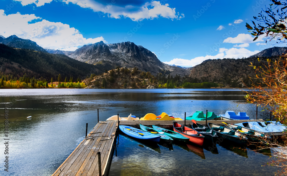 Colorful kayaks and boats in Gull lake, Sierra mountains