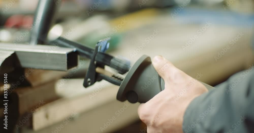 industry worker metal part with electric hacksaw industry worker metal part with electric hacksaw