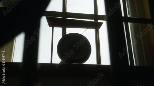 Walk through the bars to a small illuminated gong at the window