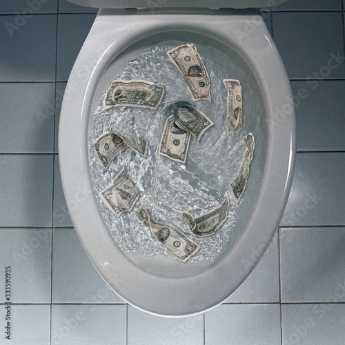 Overhead shot of money being flushed in the toilet - great for background