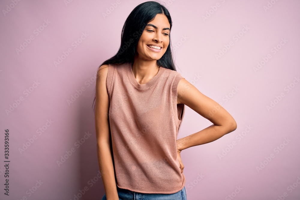 Young beautiful woman wearing fashion urban clothes, model wearing casual street style standing over pink background Young beautiful woman wearing fashion urban clothes, model wearing casual street style standing over pink background