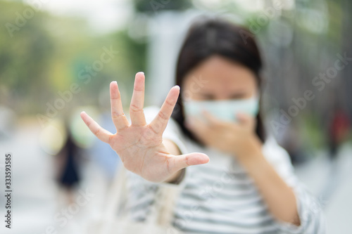 Woman wearing face mask protect filter against air pollution (PM2.5) or wear N95 mask. protect pollution, anti smog and Covid 19 viruses, Air pollution caused health problem. Global warming.