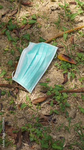 litter the garbage of used surgical mask and throw on the ground,hazardous waste,risk of disease, spreading of germ,Covid-19,flu,Influenza virus,concept of throwing carelessly medical trash.