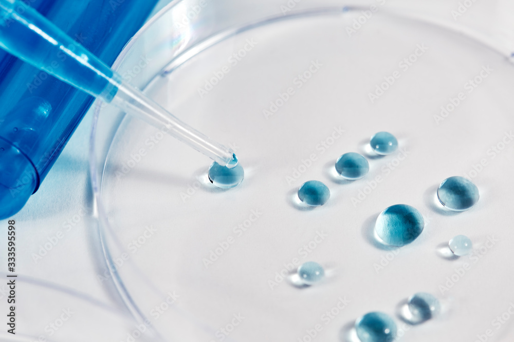 Blue Liquid dropping into a Petri Dish