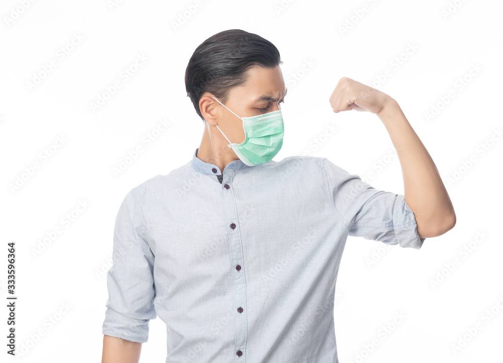 Young Asian businessman in hygienic mask showing strength to prevent infection, 2019-nCoV or coronavirus. Airborne respiratory illness such as pm 2.5 fighting and flu. Studio shot isolated on white Young Asian businessman in hygienic mask showing strength to prevent infection, 2019-nCoV or coronavirus. Airborne respiratory illness such as pm 2.5 fighting and flu. Studio shot isolated on white