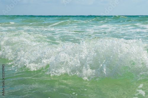 close up of waves in the sea in summer background or texture