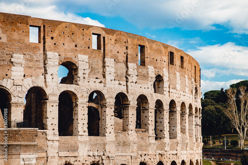 Ancient ruins Colosseum Rome, Italy, background blue sky with clouds