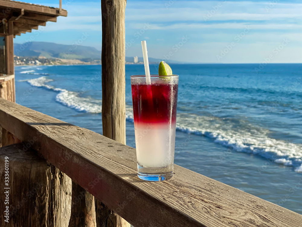 Glass of ice-cooled lemon margarita in front of the sea. Tropical destination Glass of ice-cooled lemon margarita in front of the sea. Tropical destination