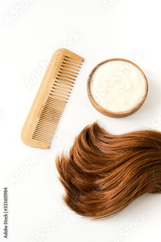 female hair, hair mask and bamboo comb on white background top view, flat lay. copy space. Self care concept.