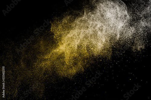 golden powder splash and brush for makeup artist or graphic design in black background