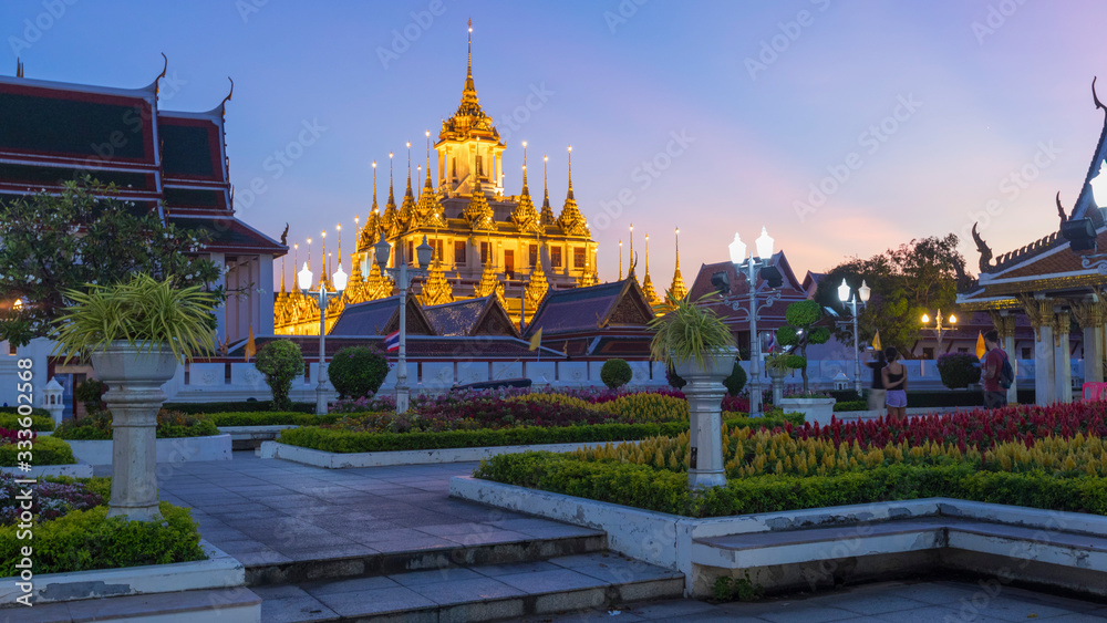 Loha Prasat chedi of the old Buddhist temple Wat Ratchanatdaram Voravihara against the sunset sky. Bangkok, Thailand