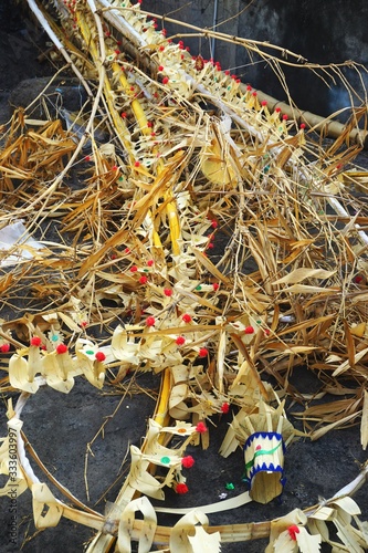 Pile of discarded festival decorations made of bamboo and palm fronds in Bali Indonesia
