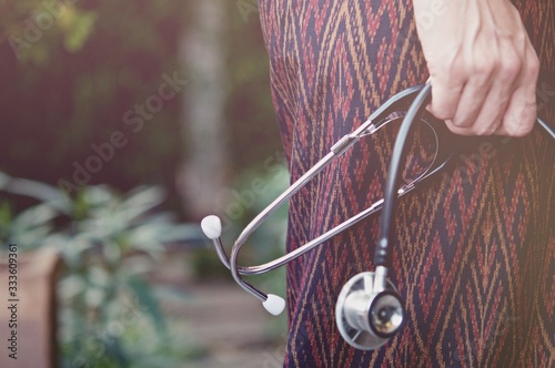 Asian woman holding Stethoscope in her hand, she worried about Covid-19 situations.