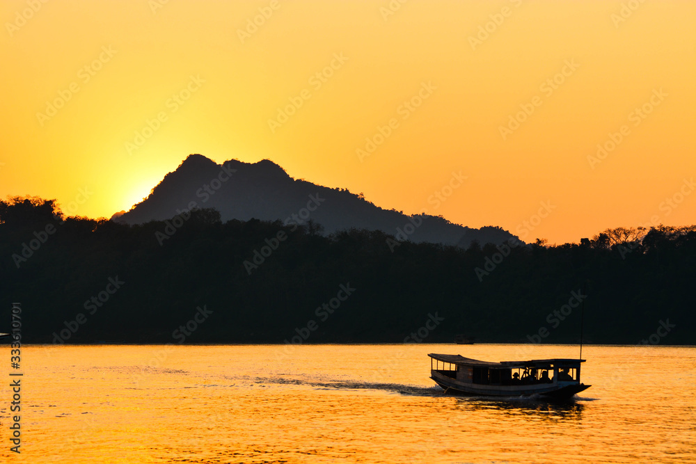 Travel boat on the Mekong River in the evening, Luang Prabang, Laos
