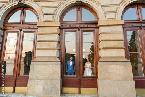 Loving couple hid behind glass doors