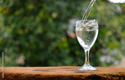 Glass of water on wood table background