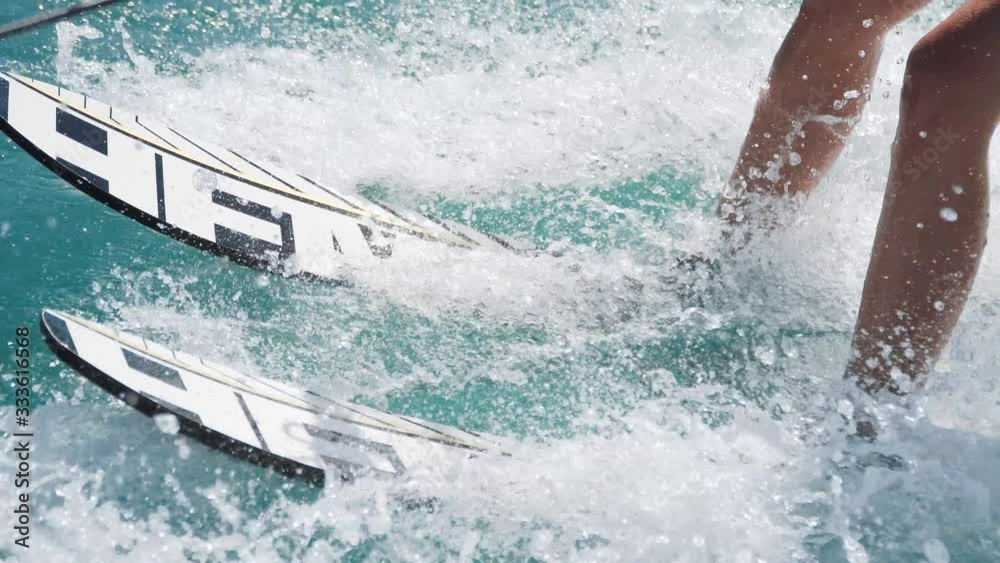 Water ski riding, sea waves around. Waterskiing summer activity on vacations. Modern sports and active lifestyle for youngsters.
