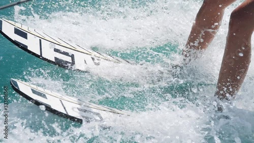 Water ski riding, sea waves around. Waterskiing summer activity on vacations. Modern sports and active lifestyle for youngsters.