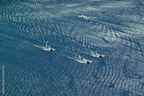 Speedboat wakes form abstract pattern in lake, New Melones Reservoir, California  photo