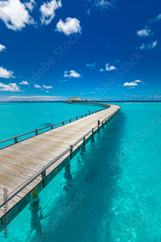 Perfect landscape of Maldives beach. Tropical panorama  luxury water villa resort with wooden pier or jetty. Luxury travel destination background for summer holiday and vacation concept.