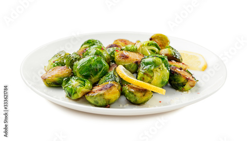 Homemade roasted brussel sprouts with parmesan cheese and butter sauce isolated on white background