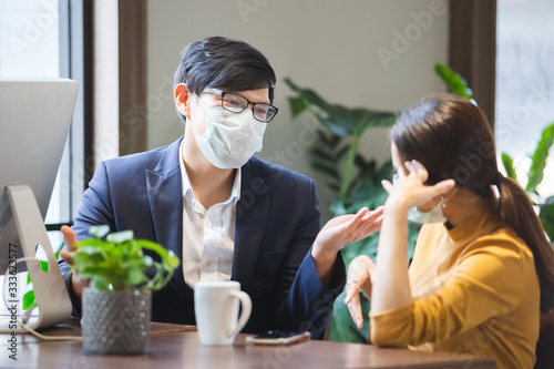 Картината върху платно asian business people with wearing hygienic mask prophylactic manager talking in meeting work room planning