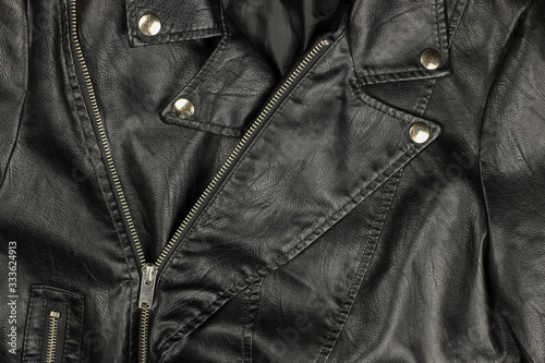 Close-up of vintage Moto black leather jacket details-collar, locks, rivets © Michael