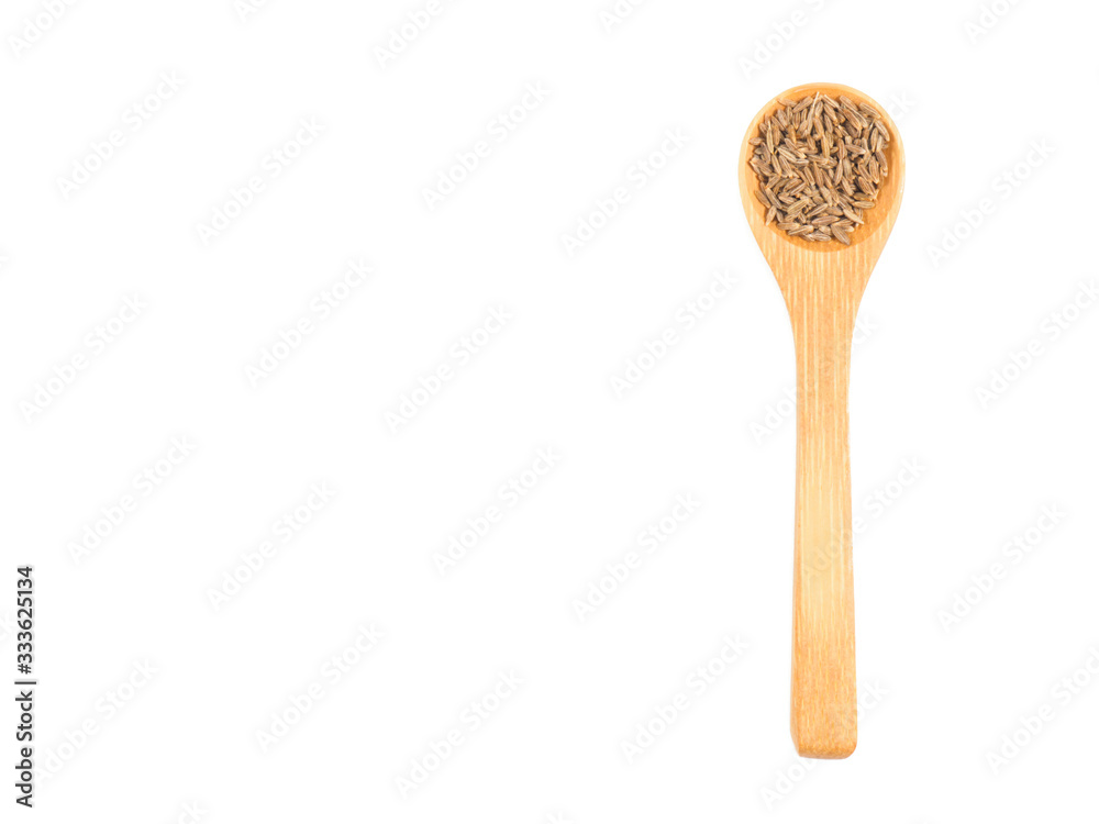 Spice cumin (jeera) in wooden spoon isolated on white Spice cumin (jeera) in wooden spoon isolated on white