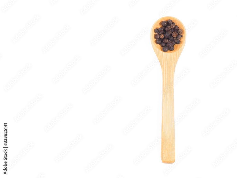 Spice black pepper in wooden spoon isolated on white