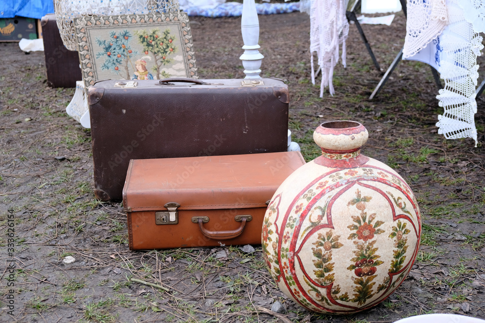 Obraz premium Two Old retro travel bags and jug on flea market