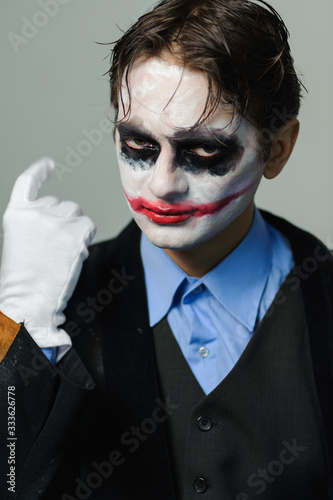 Portrait young man actor with bright makeup  role of clown posing