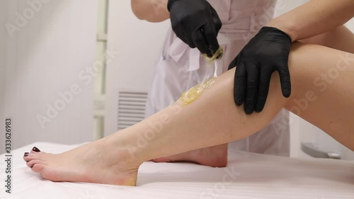 Epilation sugar processes woman passes in a beauty salon. Woman sugaring