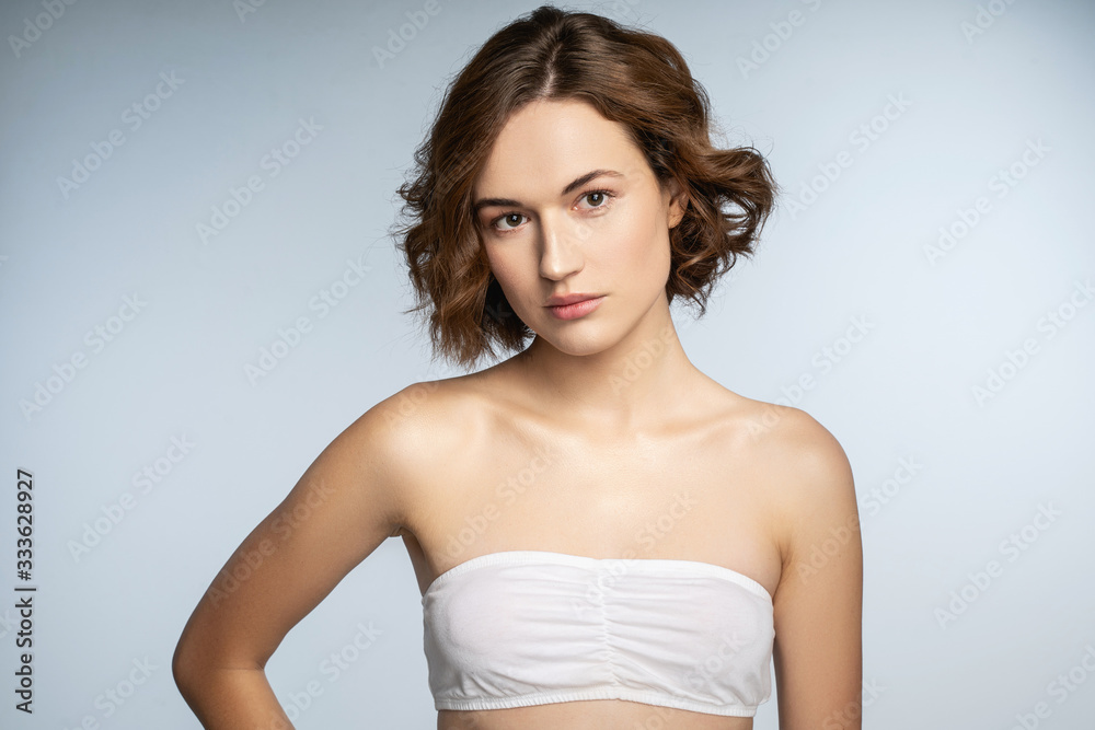 Kind young woman standing on isolated background Kind young woman standing on isolated background
