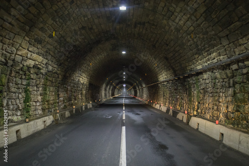 Hochtor tunnel on Grossglockner, at night time, illuminated by lights.